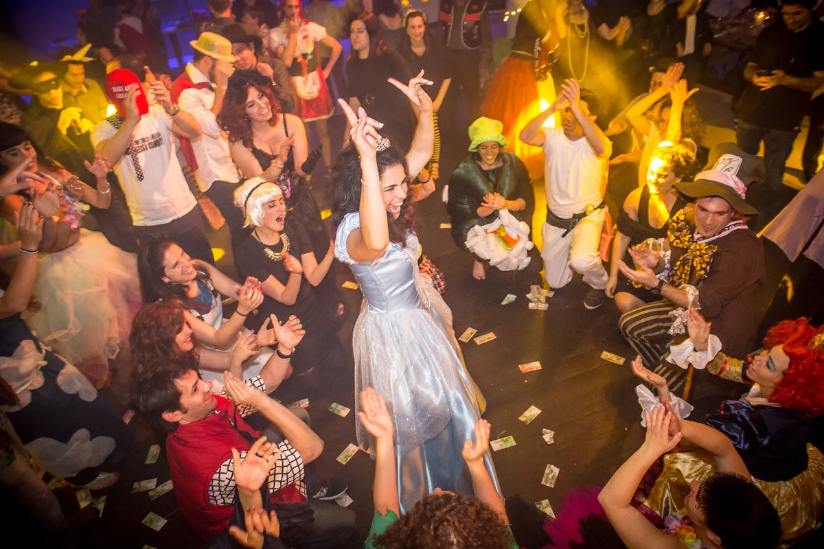 Bride in a light blue dress dancing in the middle of a circle of wedding guests