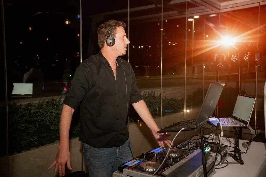 Gilad behind the decks at an outdoor wedding